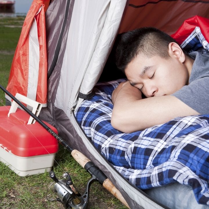 man sleeping in a tent